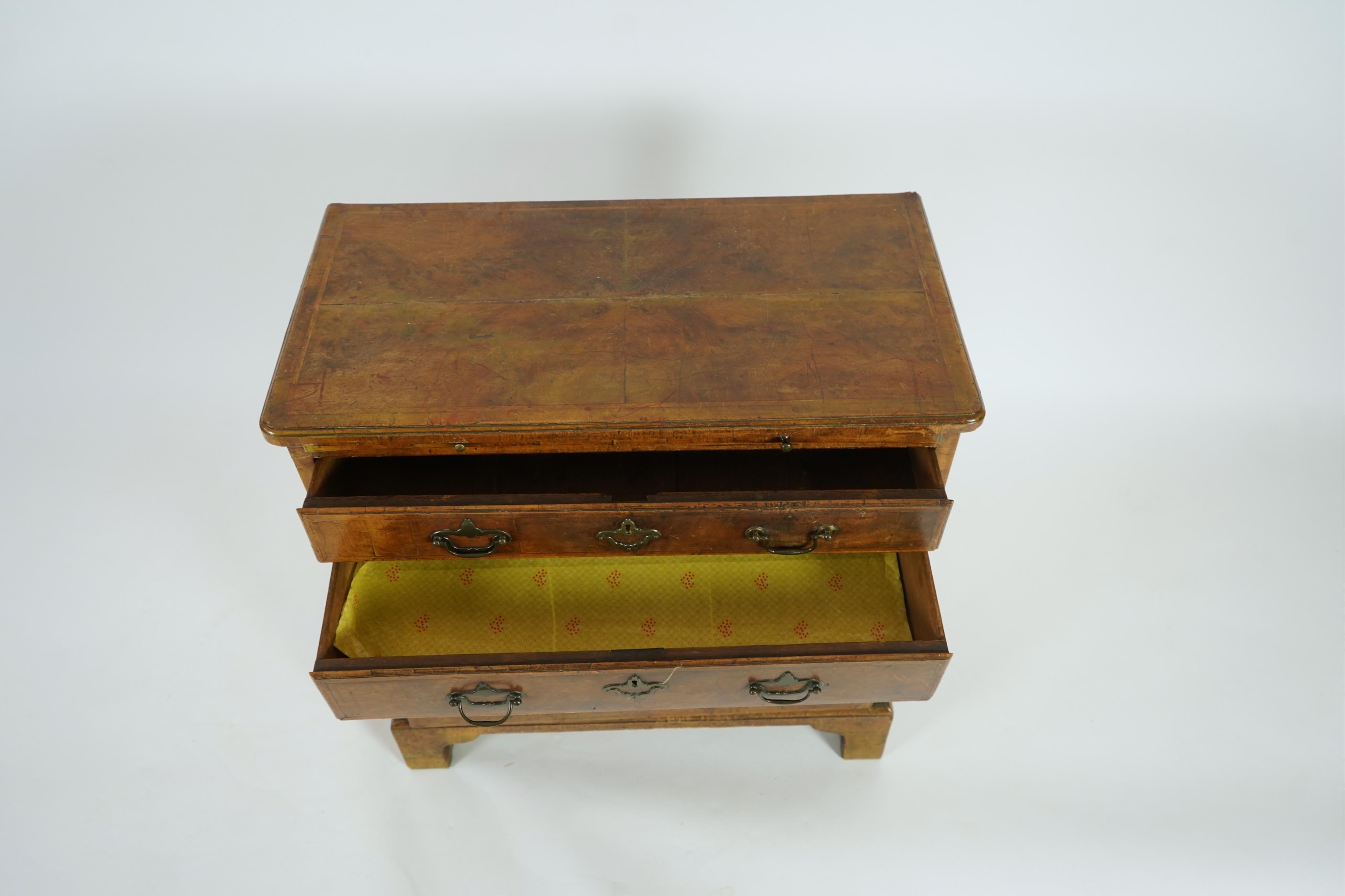 A small early 18th century and later cross and feather banded walnut veneered chest